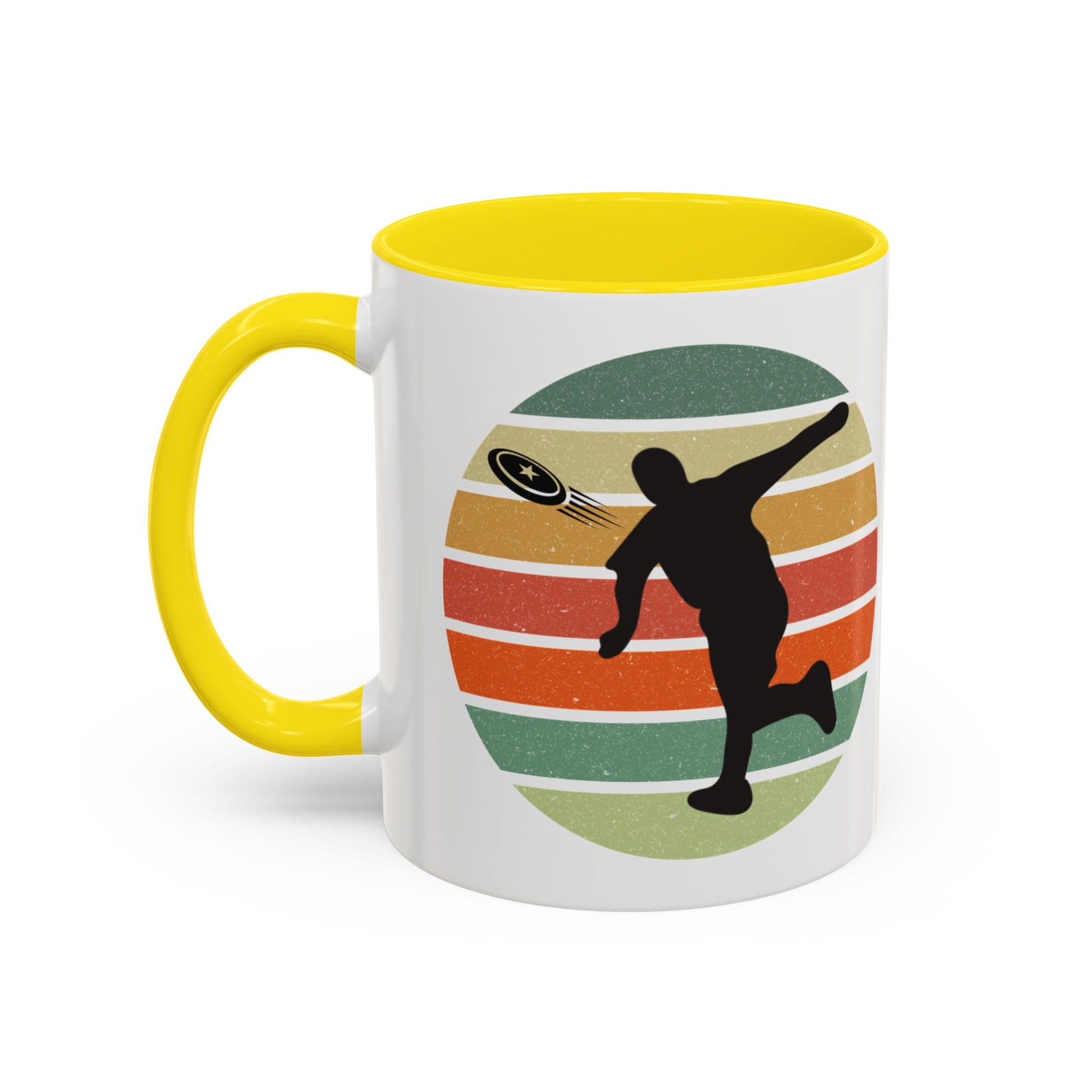 White ceramic coffee mug with yellow accents on the handle and inside. The mug features a graphic of a silhouette of a disc golf player above a colorful retro design.