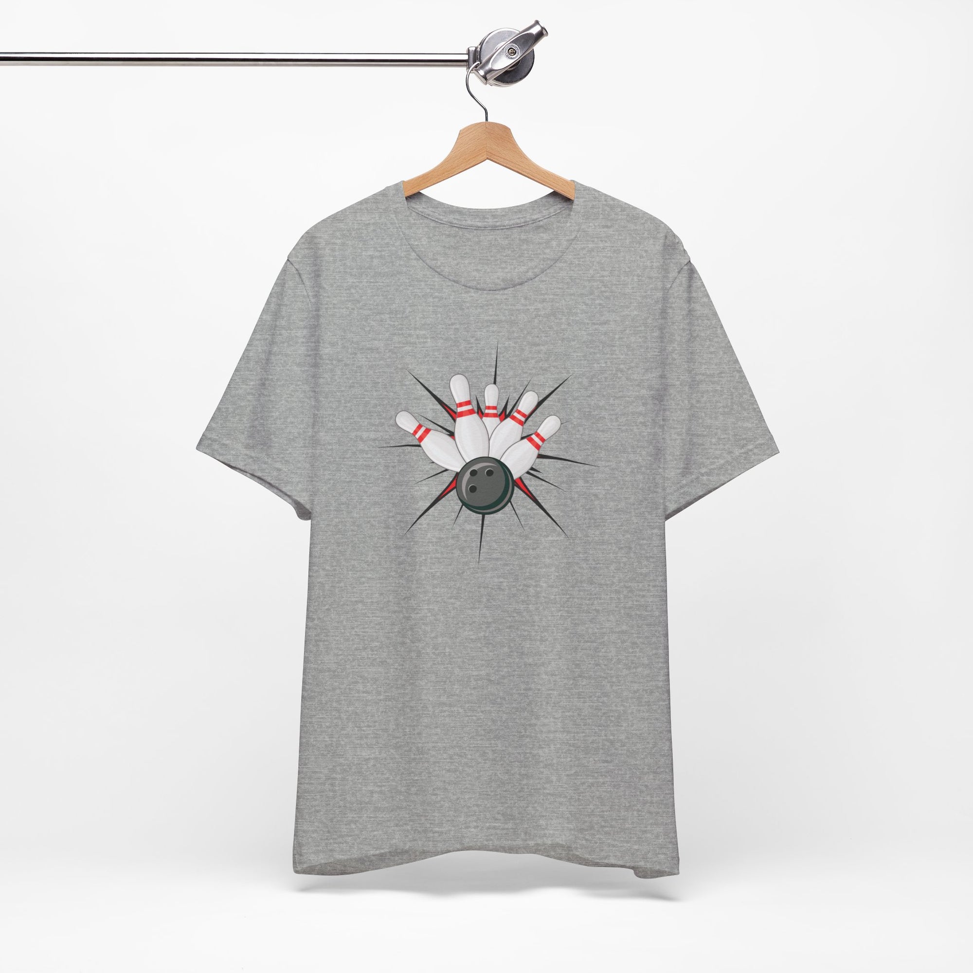 Gray t-shirt with a graphic design of a bowling ball smashing into pins on a hanger against a white background