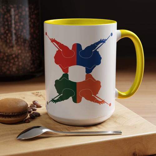 A white ceramic coffee mug with yellow accents on the handle and interior, with colorful graphic of 4 billiards player silhouettes in a pop art style, in a coffee shop setting