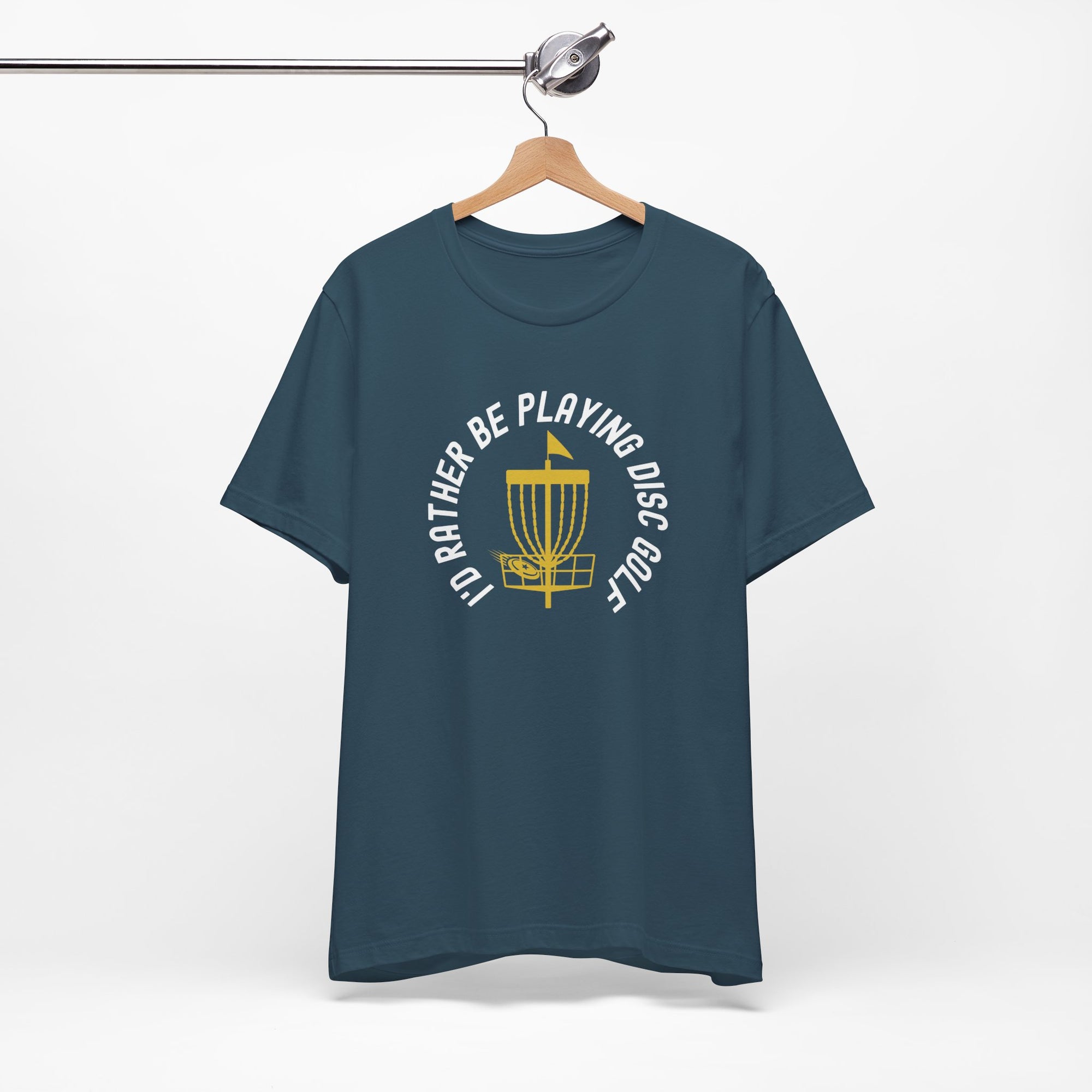 Teal t-shirt with a graphic of disc golf chains, basket, and disc and text that says "I'd Rather Be Playing Disc Golf" on a hanger against a white background