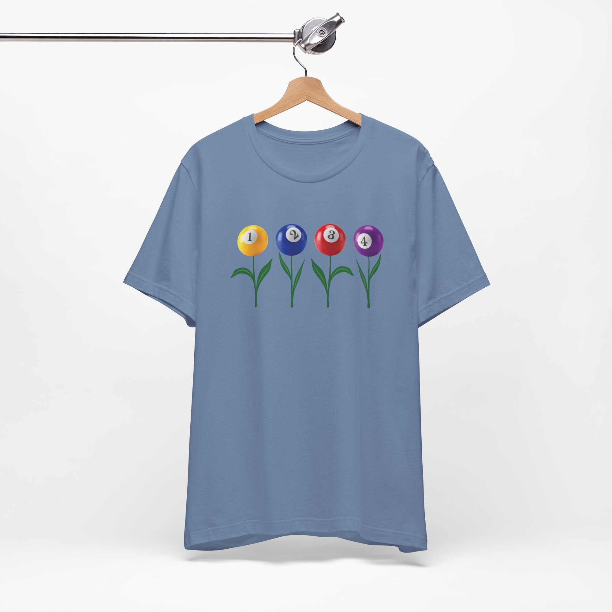 Steel blue t-shirt with four colorful flowers made out of billiards balls with green stems, on a hanger against a white background