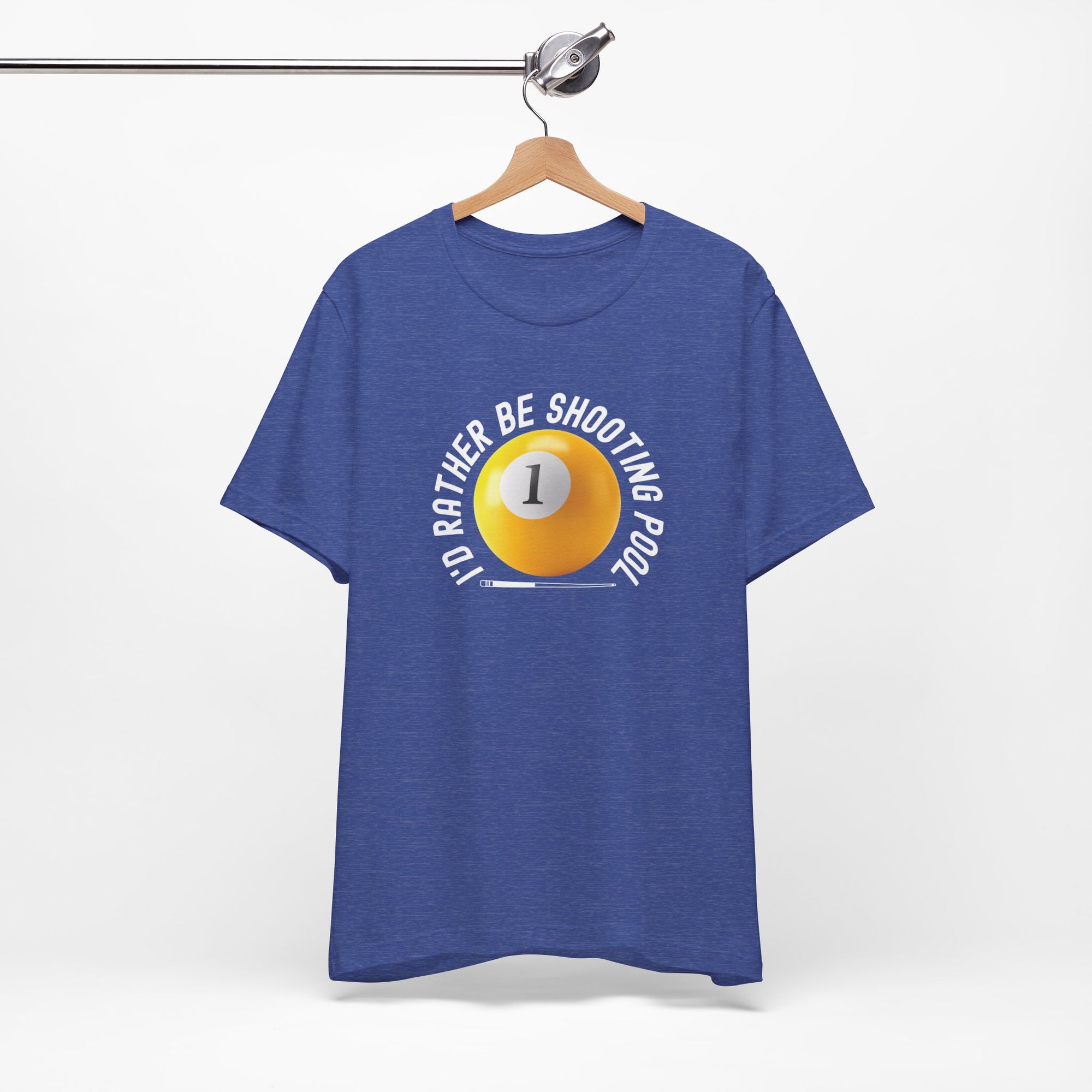 Heather blue t-shirt with a yellow billiards ball and cue stick graphic and the text "I'd Rather Be Shooting Pool" on a hanger against a white background