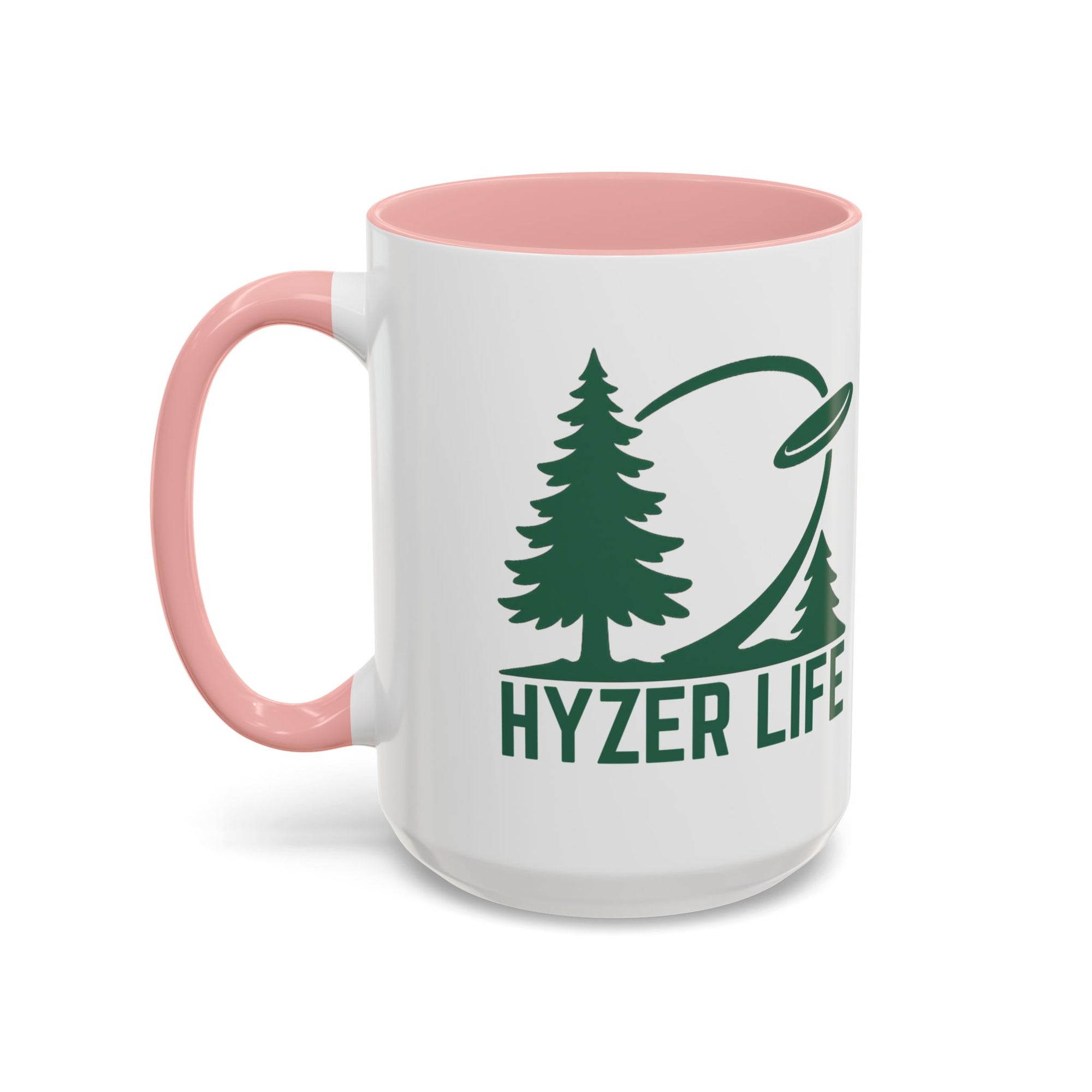 Ceramic coffee mug with pink accents on the handle and interior, with green graphic of trees and a disc golf flying with the words 'HYZER LIFE' below the image, against a white background