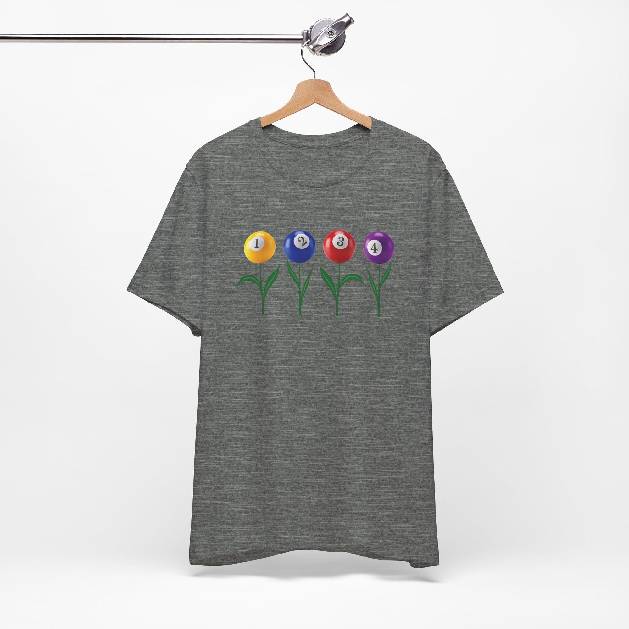 Gray t-shirt with four colorful flowers made out of billiards balls with green stems, on a hanger against a white background