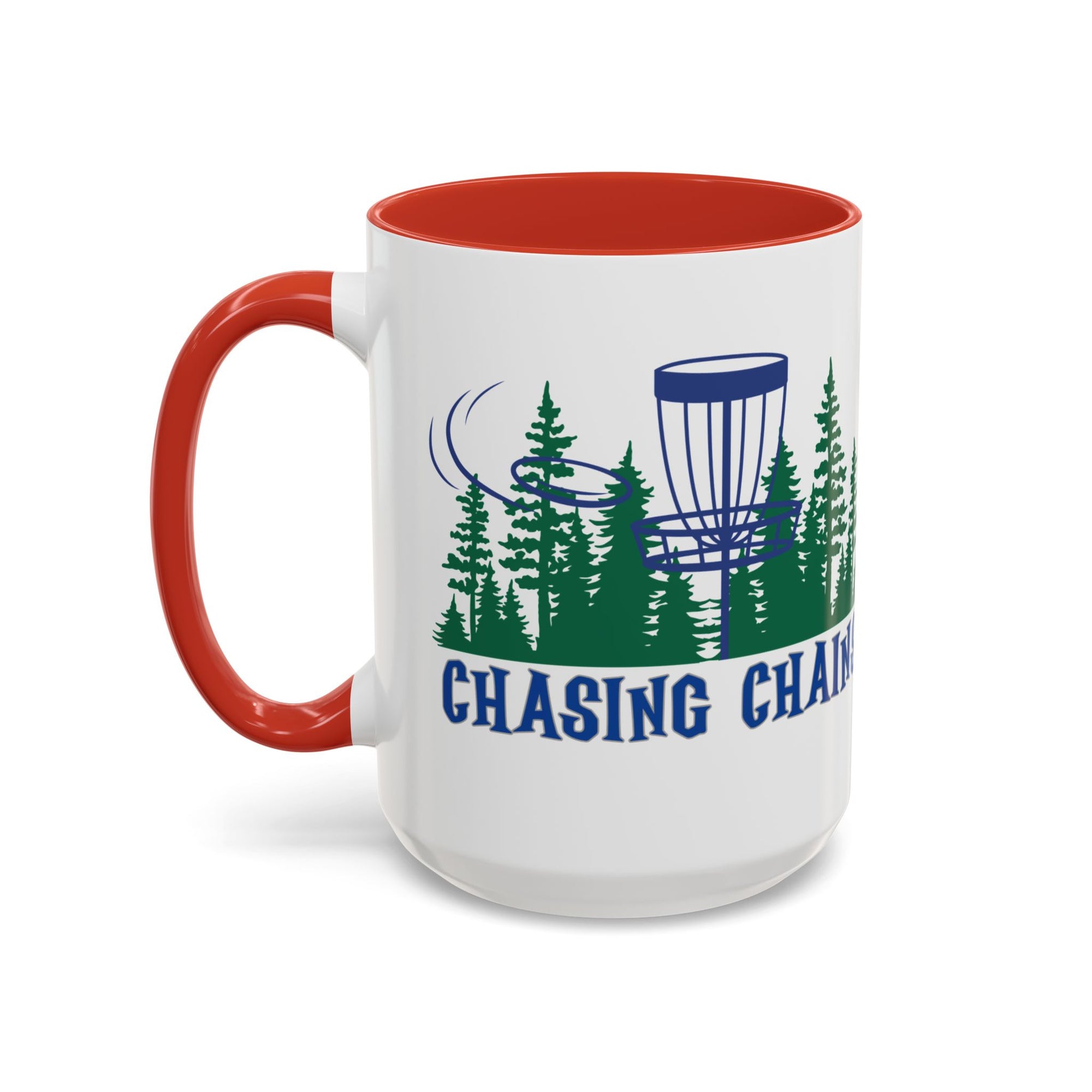 A ceramic coffee mug with red accents on the handle and interior, with 'Chasing Chains' graphic featuring a flying disc golf disc and basket and chains in front of a scenic evergreen tree landscape, against a white background