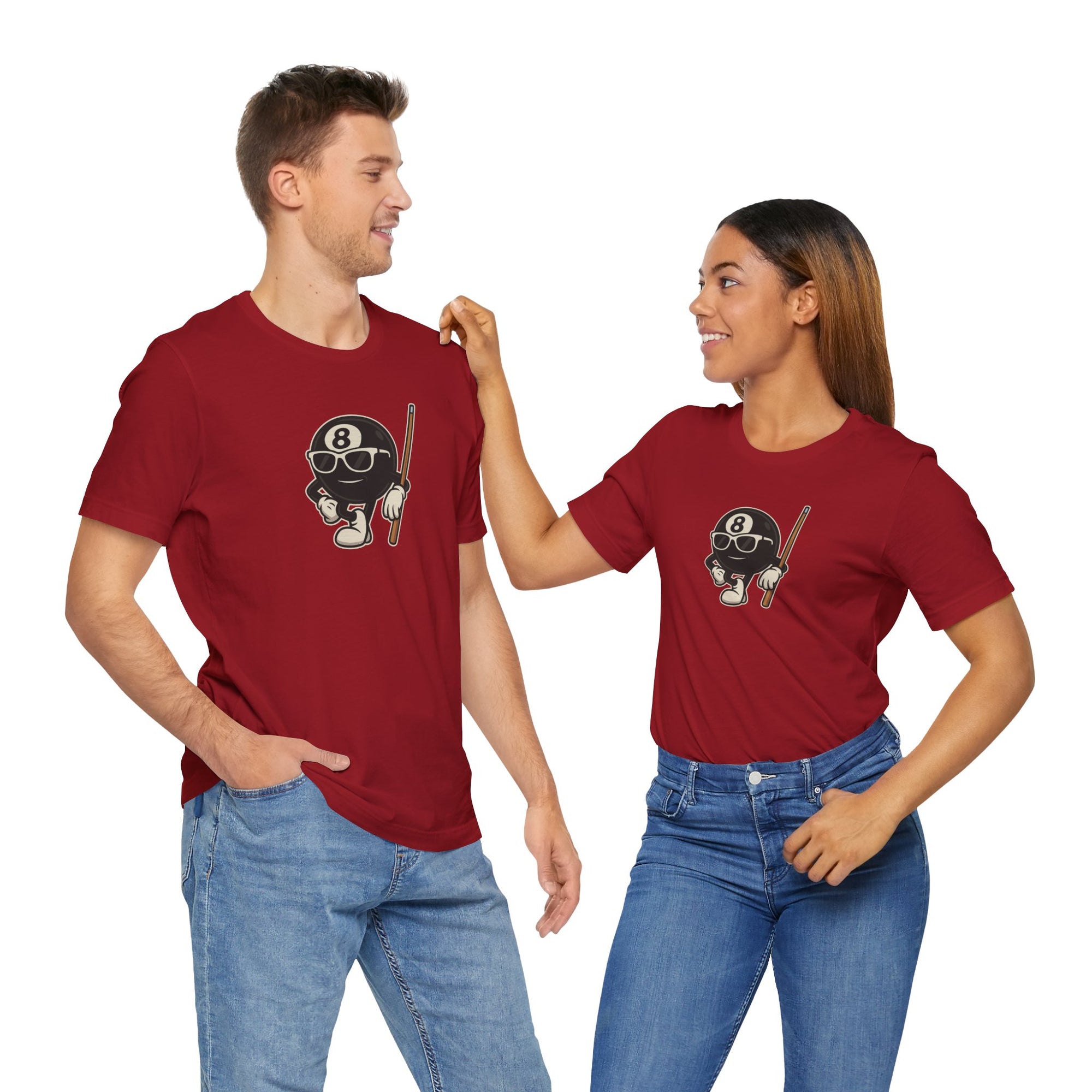 A man and a woman both wearing a red t-shirt with a graphic of a cartoon billiards 8 ball with arms and legs and wearing sunglasses and leaning on a cue stick, against a white background