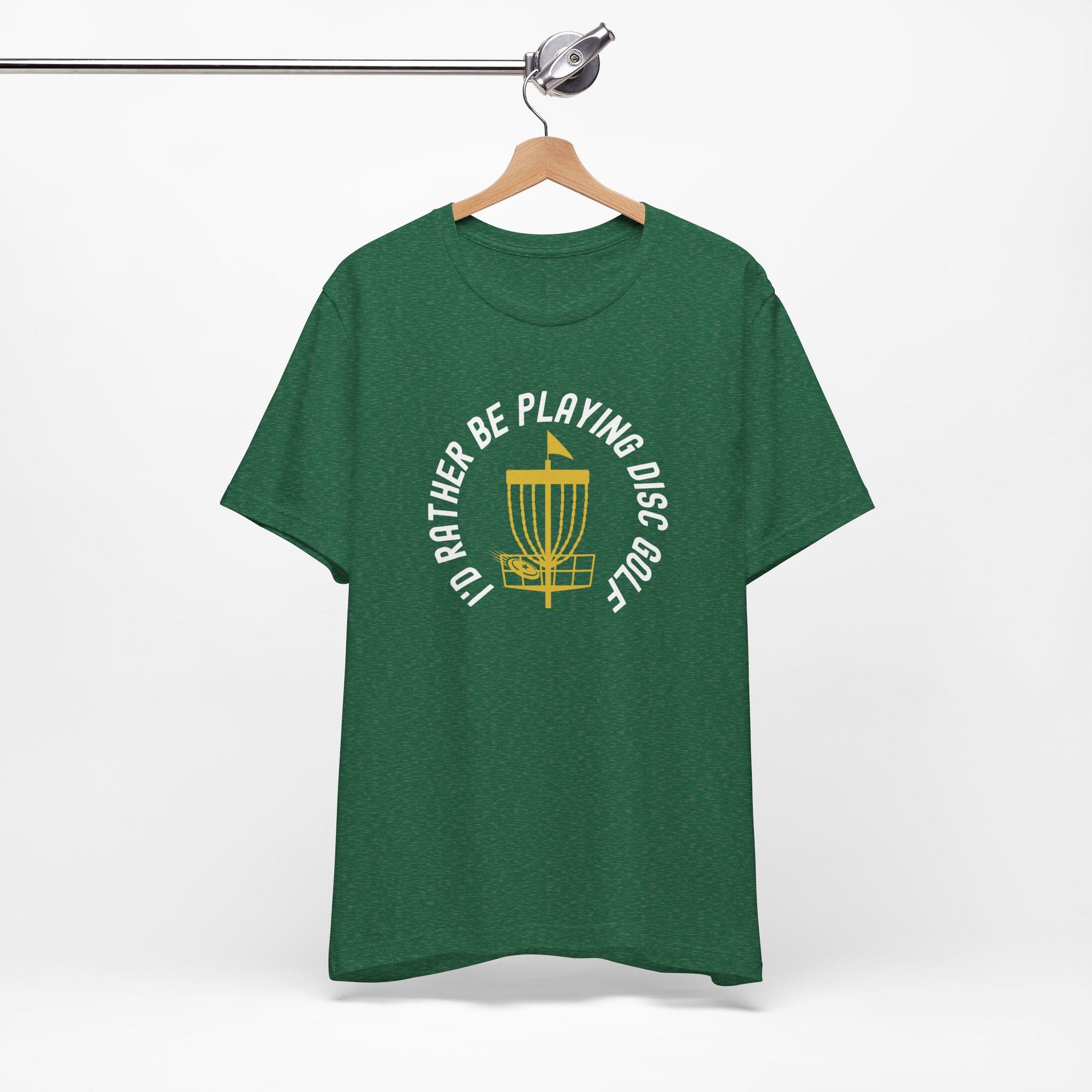 Green t-shirt with a graphic of disc golf chains, basket, and disc and text that says "I'd Rather Be Playing Disc Golf" on a hanger against a white background