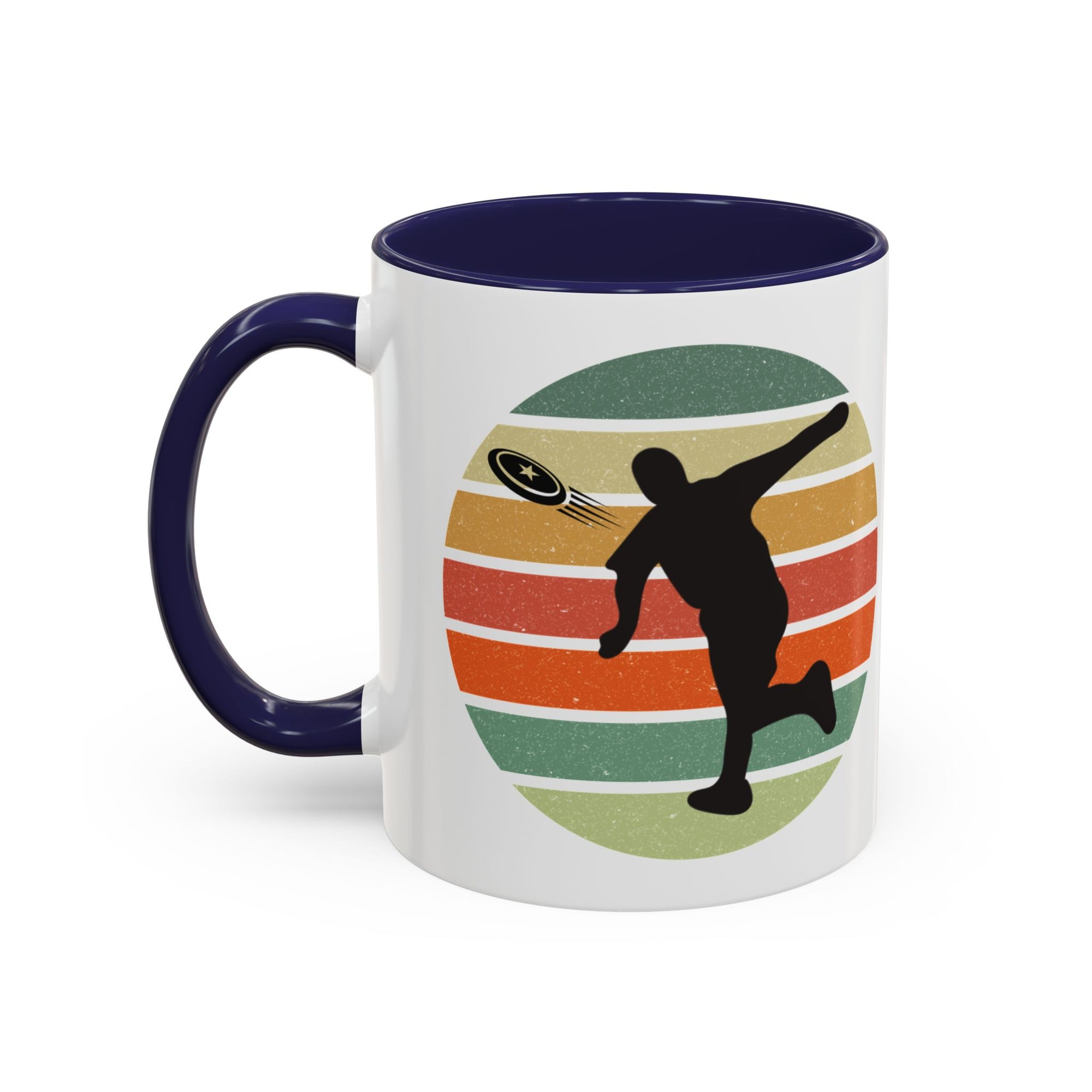 White ceramic coffee mug with dark blue accents on the handle and inside. The mug features a graphic of a silhouette of a disc golf player above a colorful retro design.