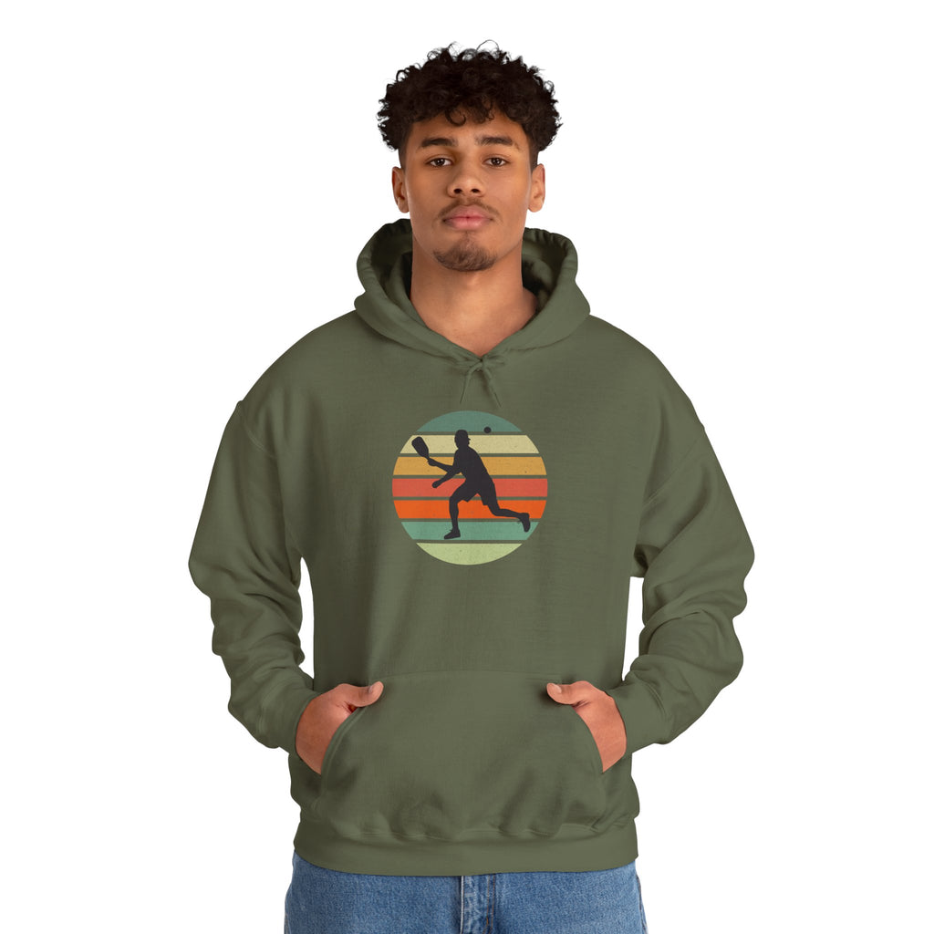 Green hoodie with a graphic of a person playing pickleball over a colorful retro background