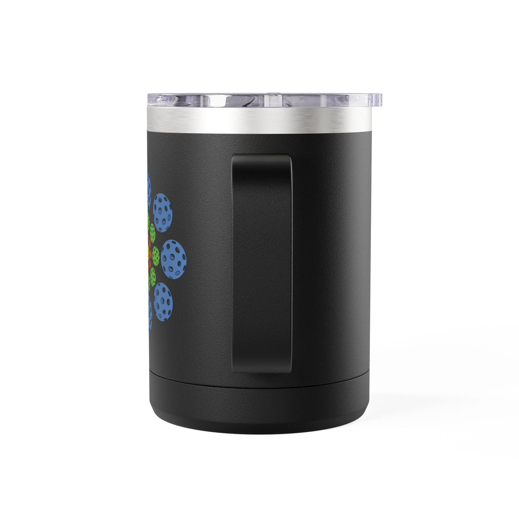 The back side of a black travel mug with lid and handle featuring a colorful geometric design of pickleballs against a white background