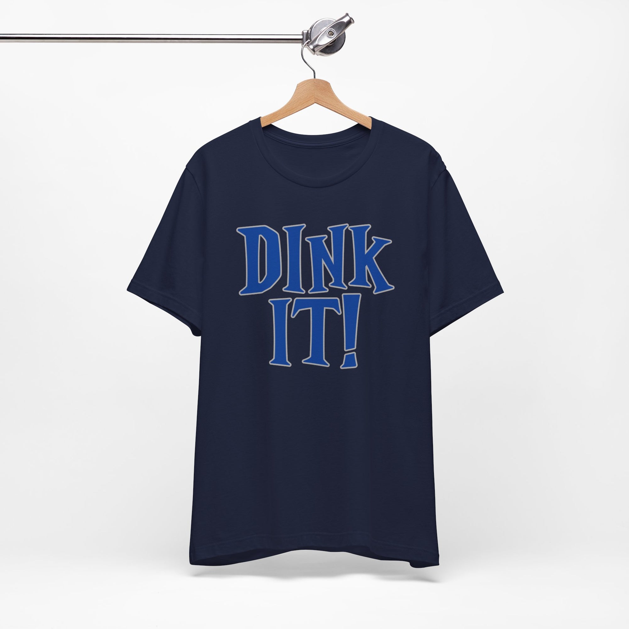 Navy blue t-shirt with 'DINK IT!' text in blue and outlined in gray, on a hanger against a white background