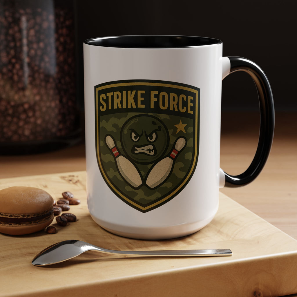 A white ceramic coffee mug with black accents on the handle and interior, with bowling 'Strike Force' military-style patch in a coffee shop setting