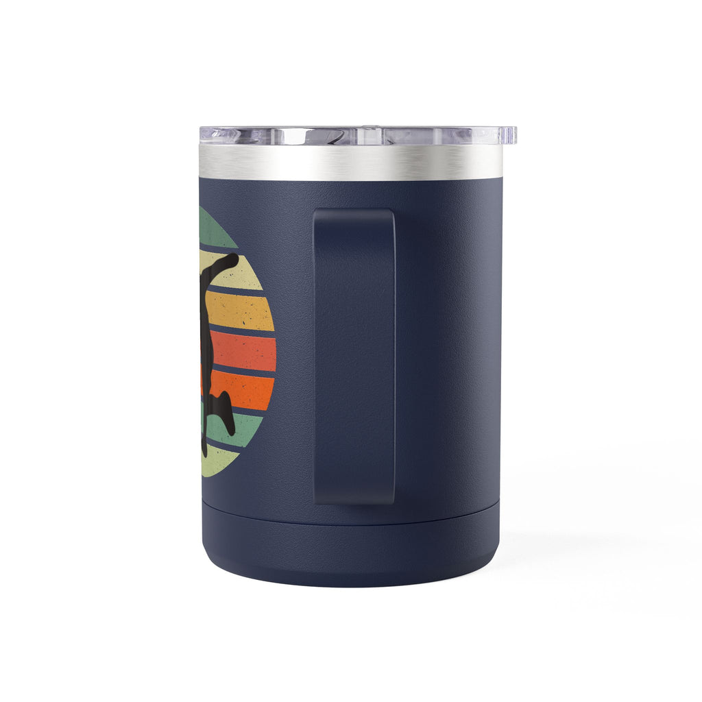 Back view of a blue stainless steel coffee tumbler with handle and lid and a design on one side featuring a silhouette of a person playing disc golf over a colorful retro image, on a white background.