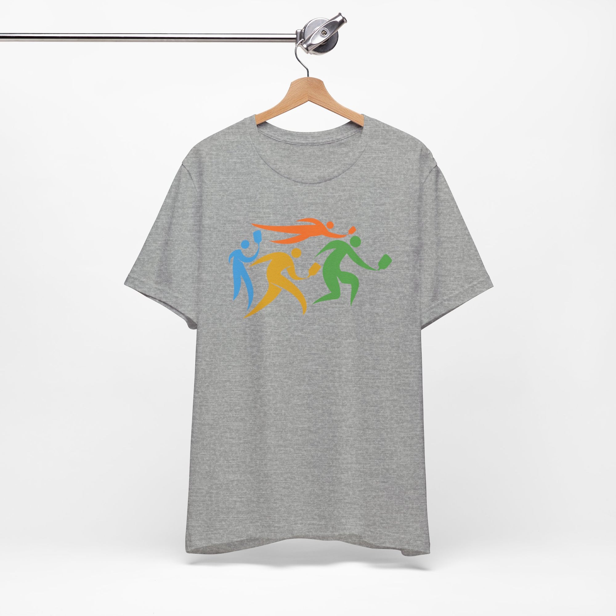 Gray t-shirt featuring an image of four colorful pickleball player drawings playing pickleball, on a hanger against a white background