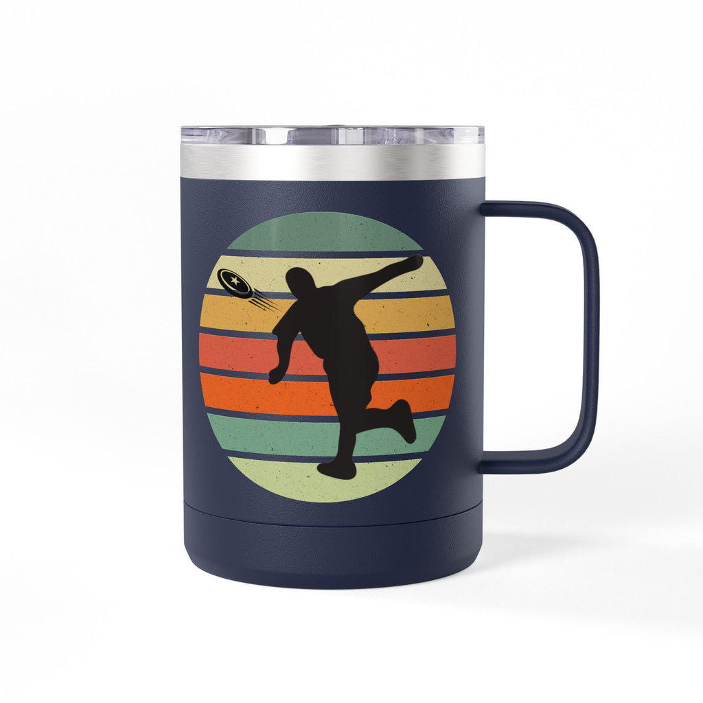 Navy blue stainless steel coffee tumbler with handle and lid and a design on one side featuring a silhouette of a person playing disc golf over a colorful retro image, on a white background.