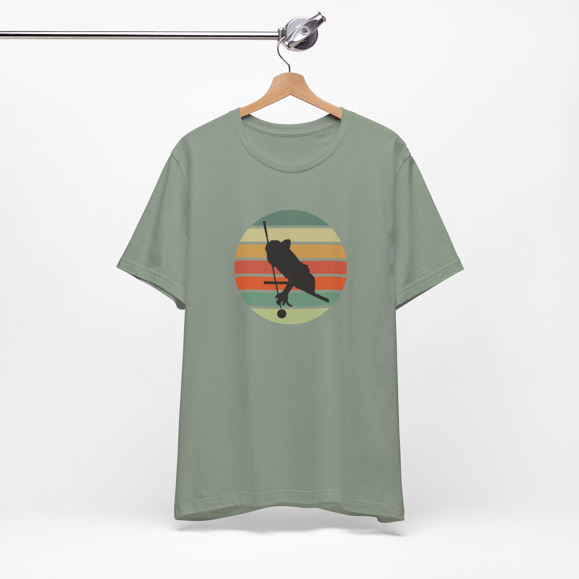 Teal t-shirt with a graphic of a billiards player silhouette over a colorful retro image against a white background