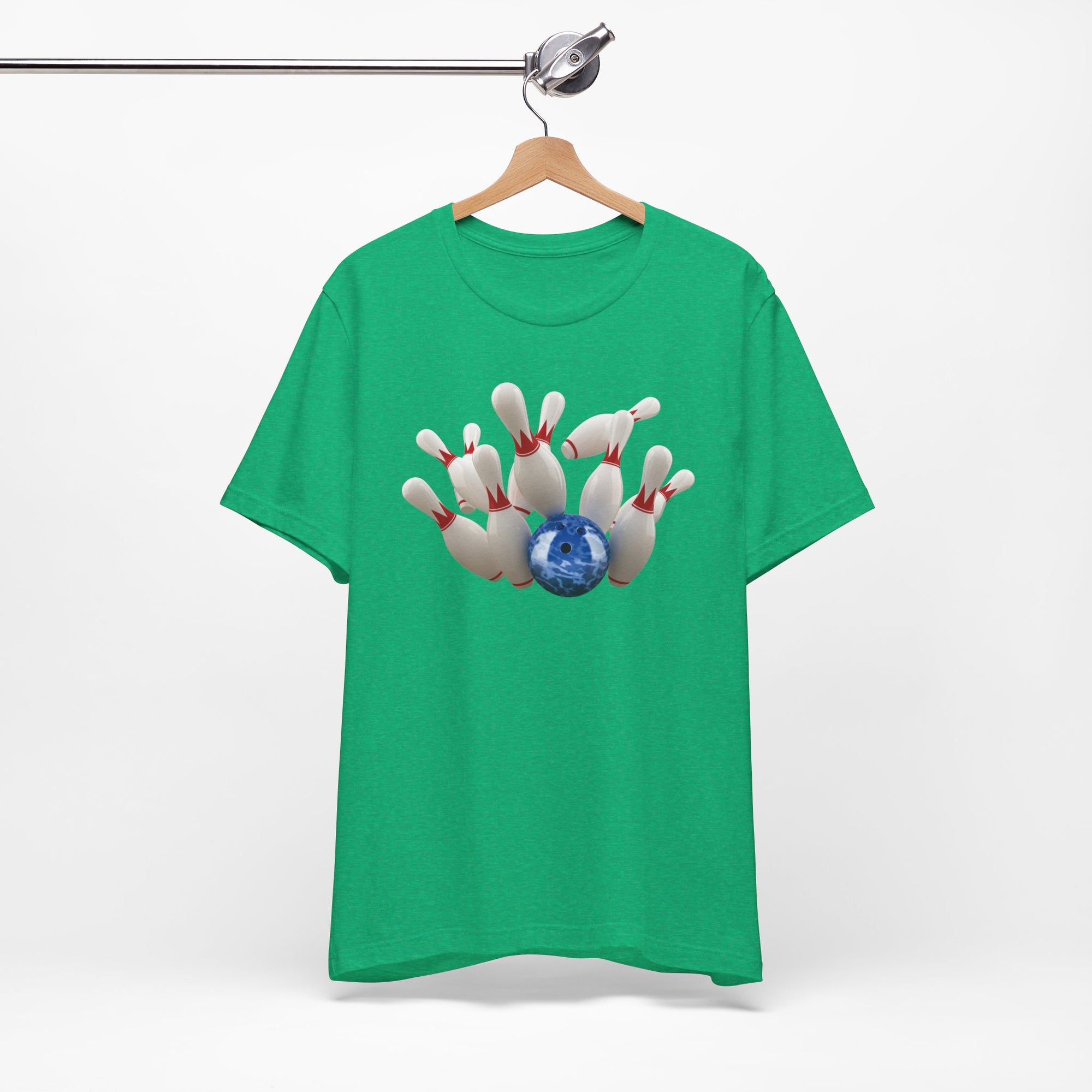 Green t-shirt with a graphic of a blue bowling ball knocking over bowling pins, on a hanger against a white background
