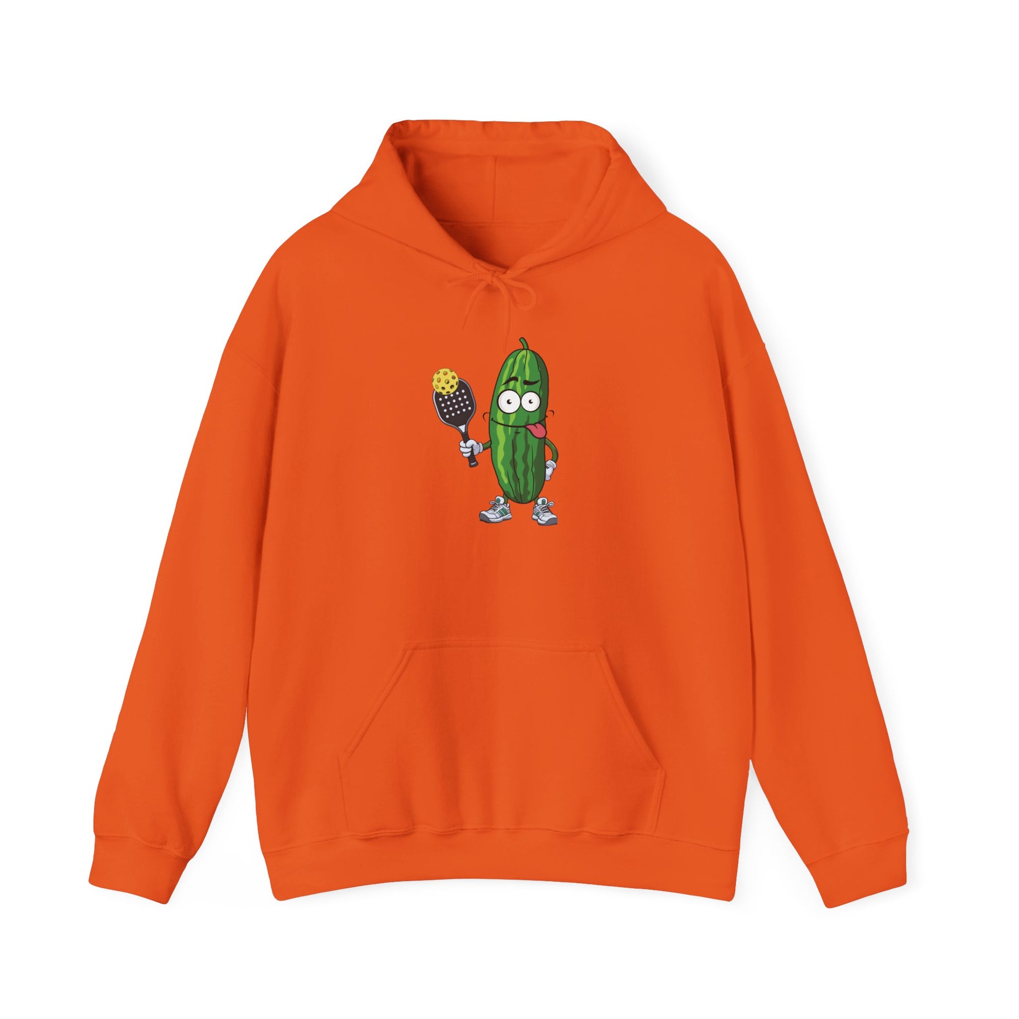 Orange hoodie with a cartoon pickle with googly eyes and his tongue sticking out, holding a pickleball paddle with a yellow pickleball, against a white background