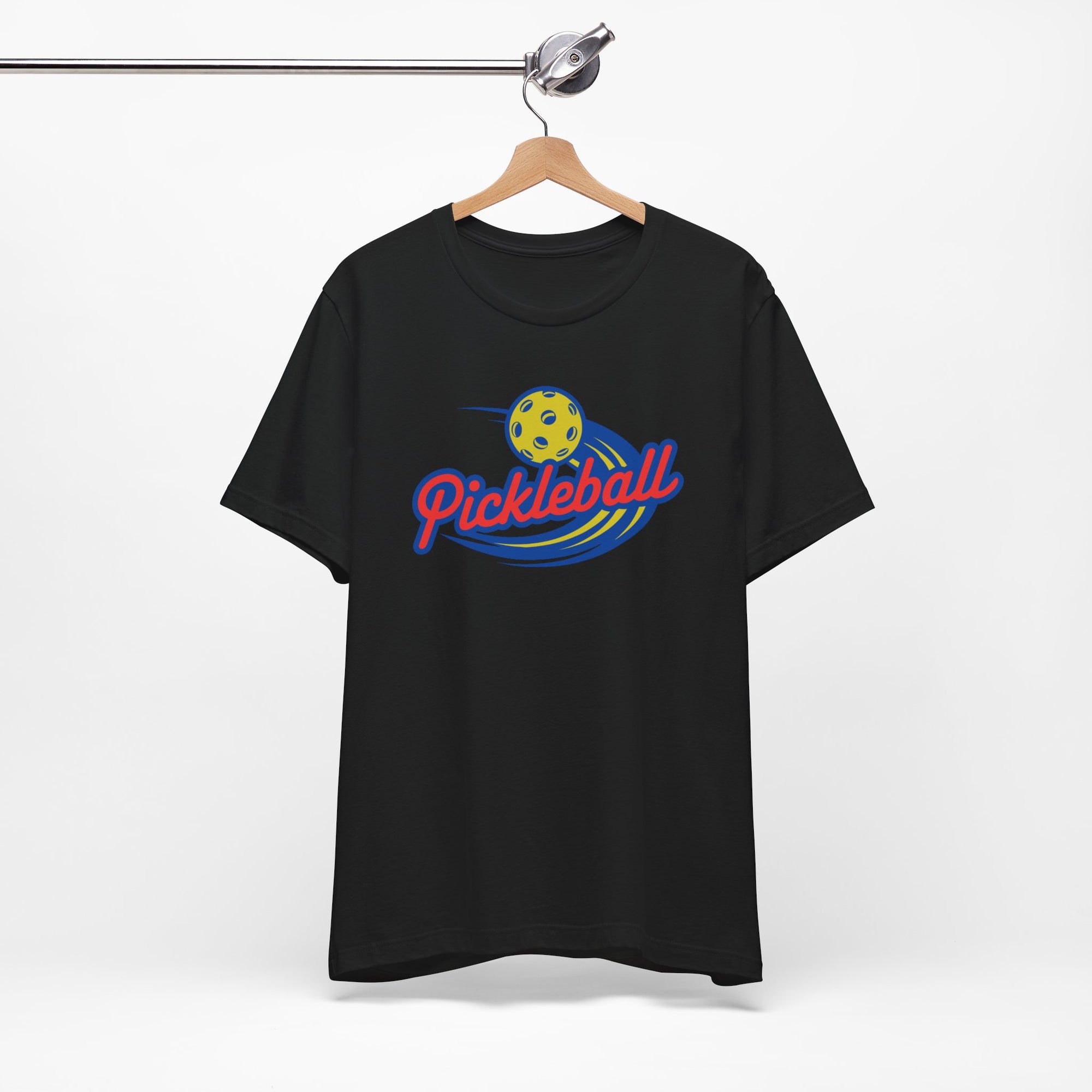 Black t-shirt with a classic pickleball logo featuring the word pickleball and a yellow pickleball with motion lines, on a hanger against a white background