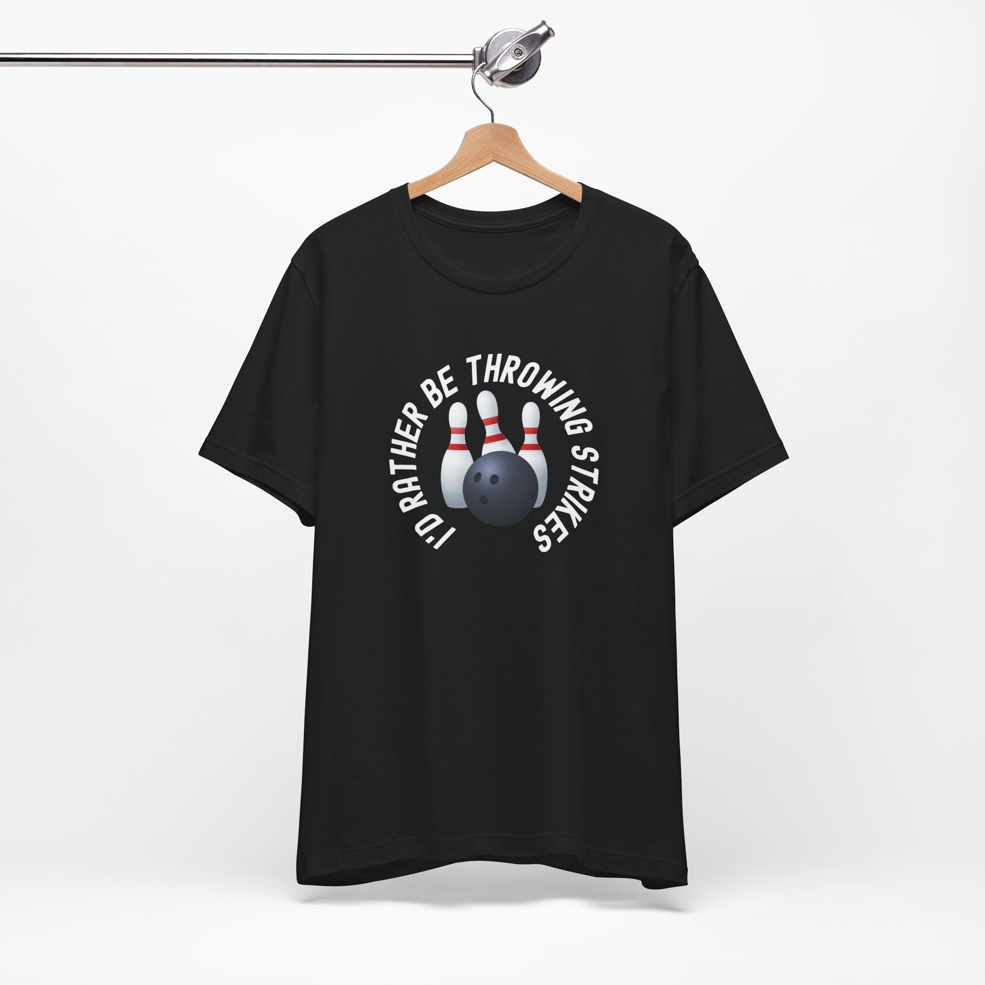 Black t-shirt with bowling pins and a bowling ball and text saying "I'd Rather Be Throwing Strikes" on a hanger against a white background