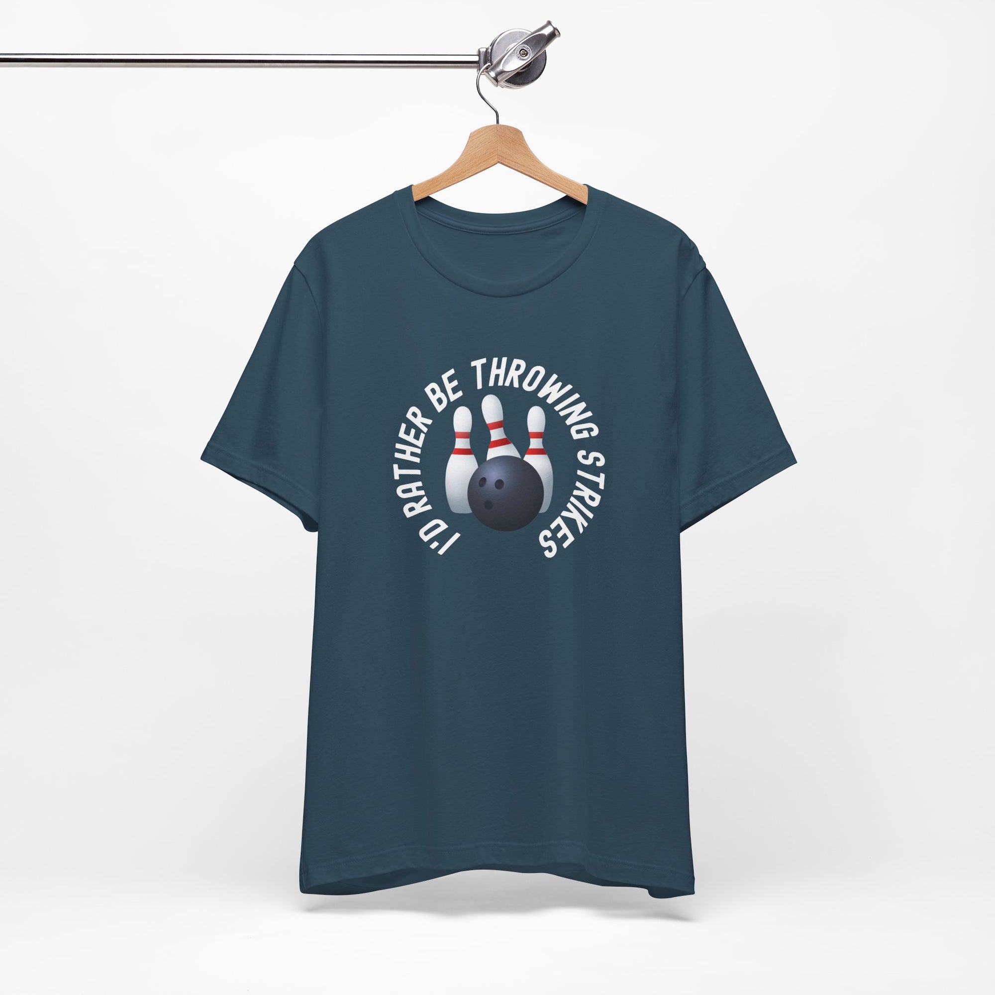 Teal t-shirt with bowling pins and a bowling ball and text saying "I'd Rather Be Throwing Strikes" on a hanger against a white background