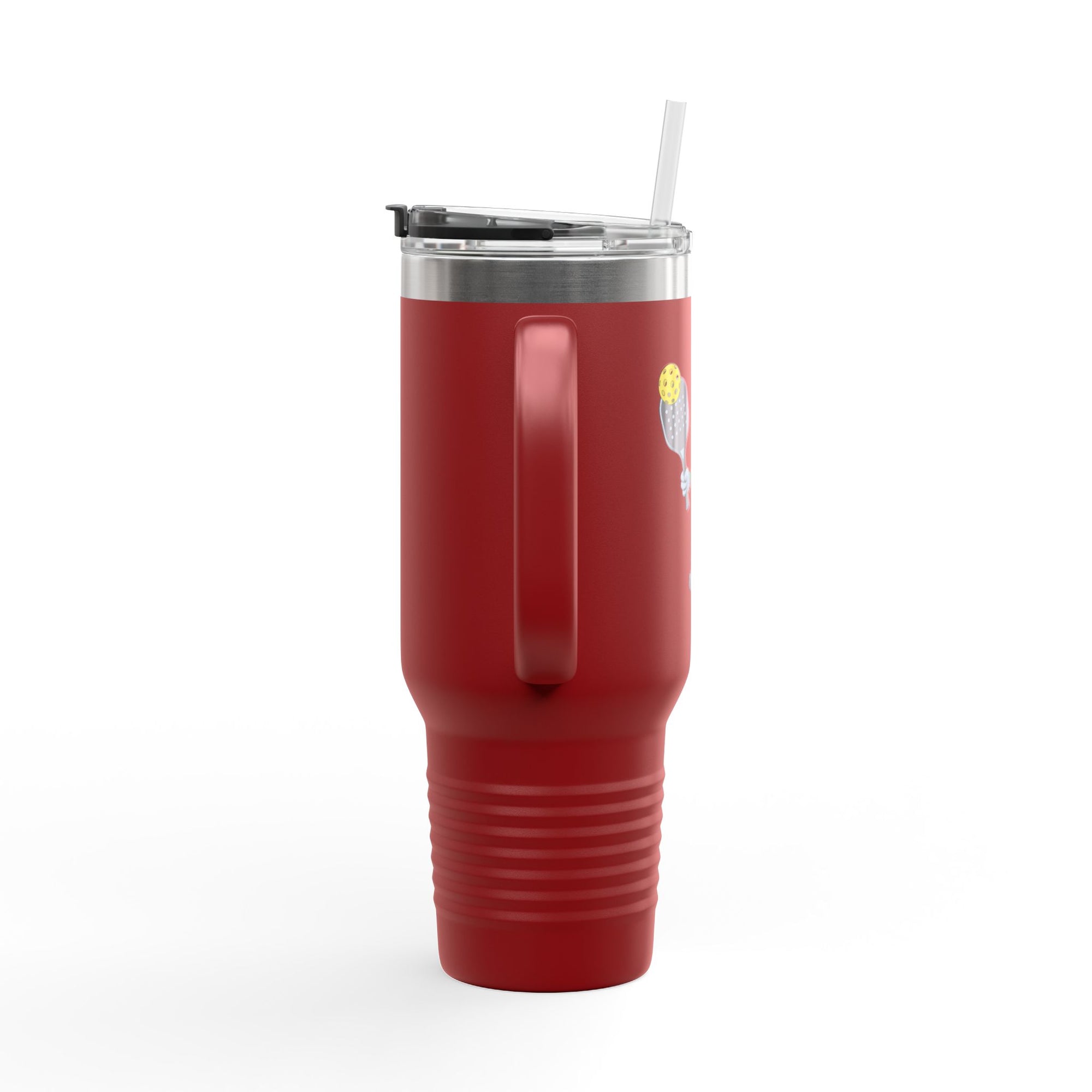 Side view of a red 40oz tumbler with lid and straw featuring a cartoon pickle with googly eyes and his tongue sticking out, holding a pickleball paddle with a yellow pickleball, against a white background