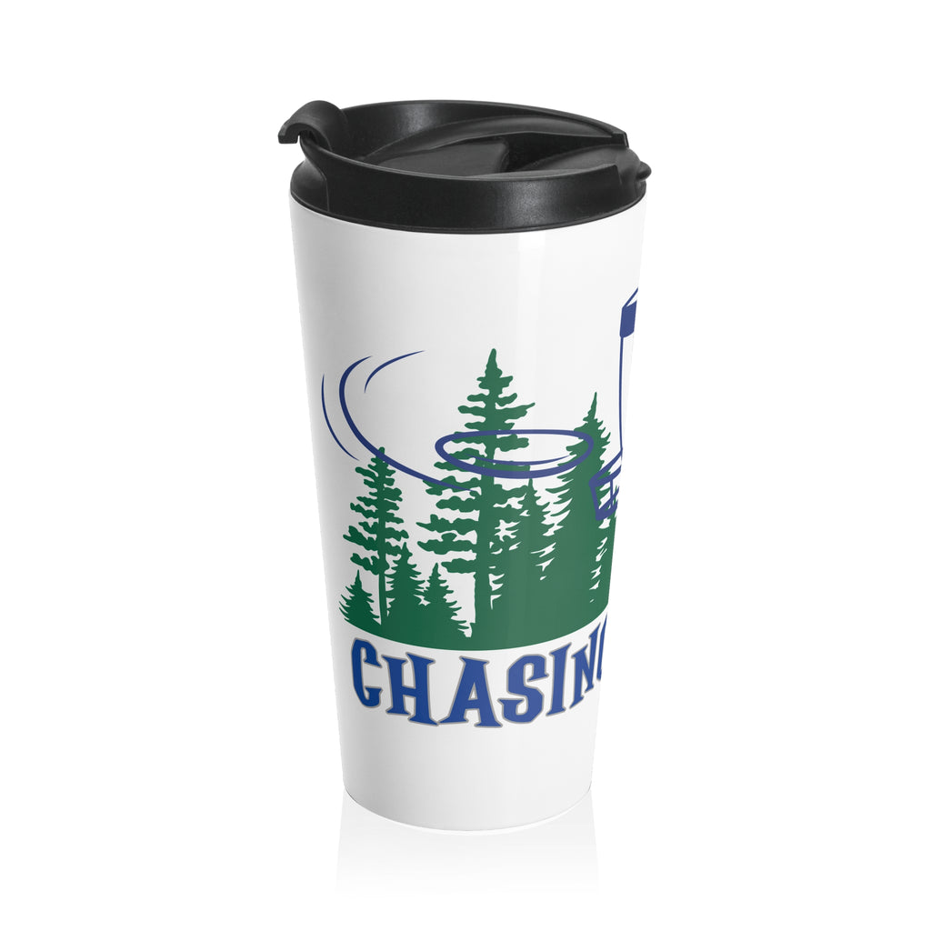 A travel tumbler mug with lid with 'Chasing Chains' graphic featuring a flying disc golf disc and basket and chains in front of a scenic evergreen tree landscape, against a white background
