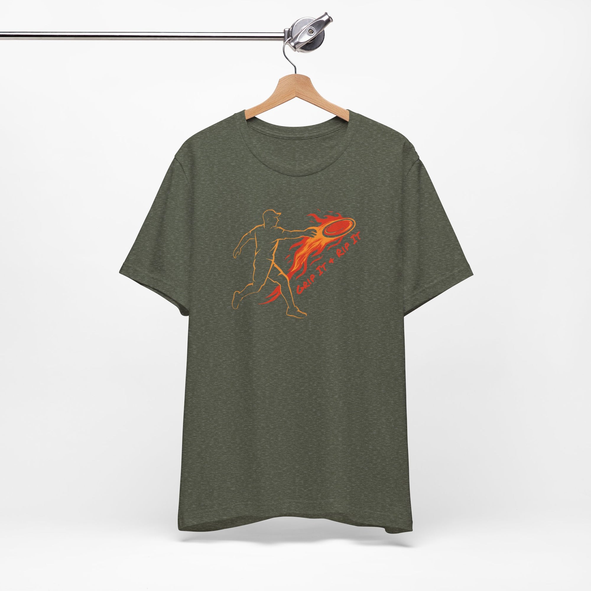 Military green t-shirt with a graphic design of a person throwing a disc golf disc with flames coming off the disc and text 'Grip It or Rip It' on a hanger against a white background.