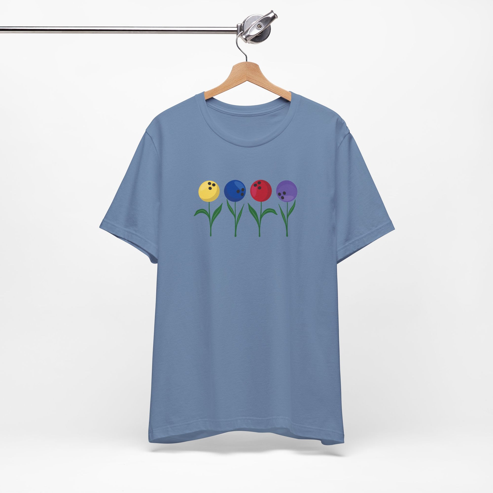 Steel blue t-shirt with colorful flowers made out of bowling balls, on a hanger against a white background