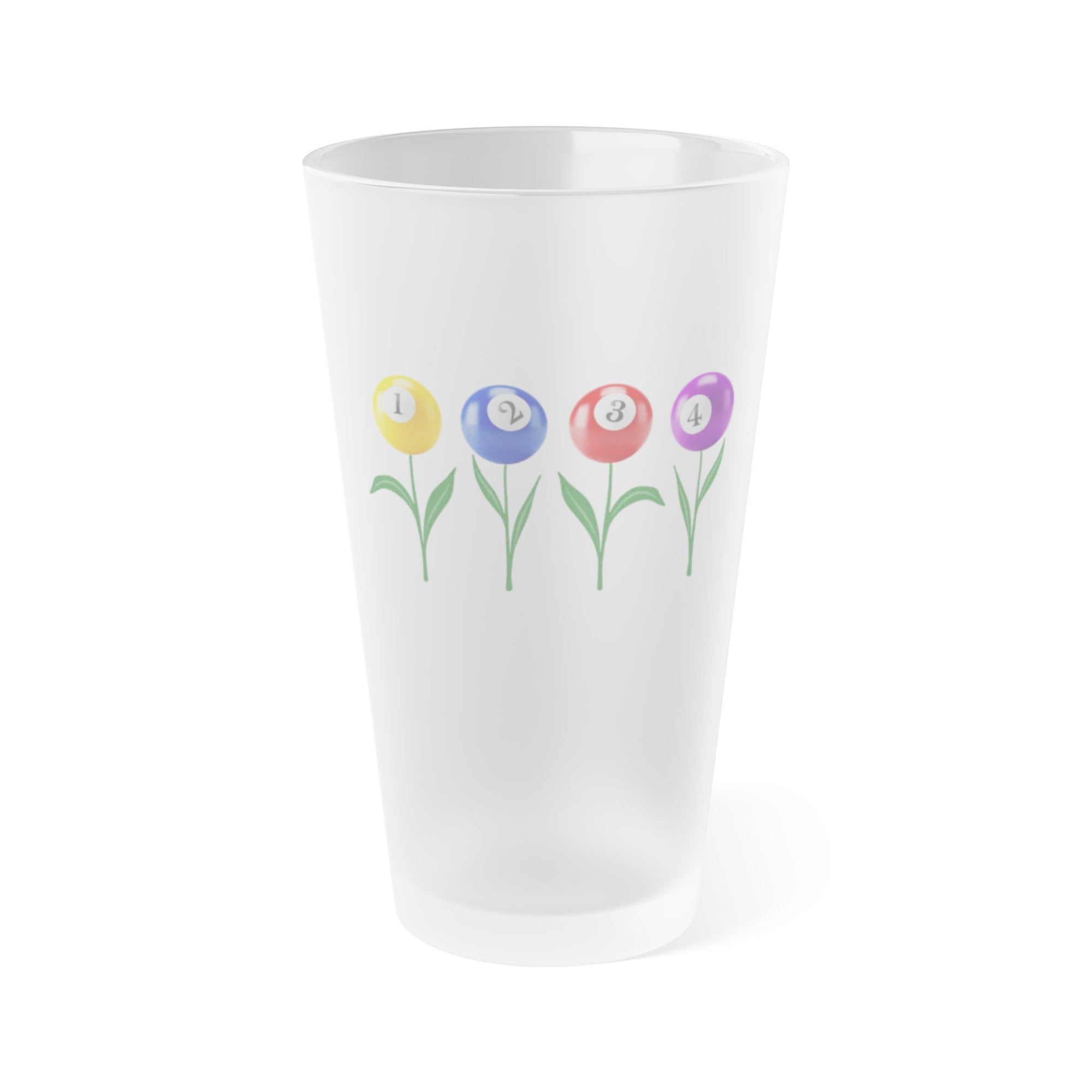 A frosted pint glass with four colorful flowers made out of billiards balls with green stems, on a white background