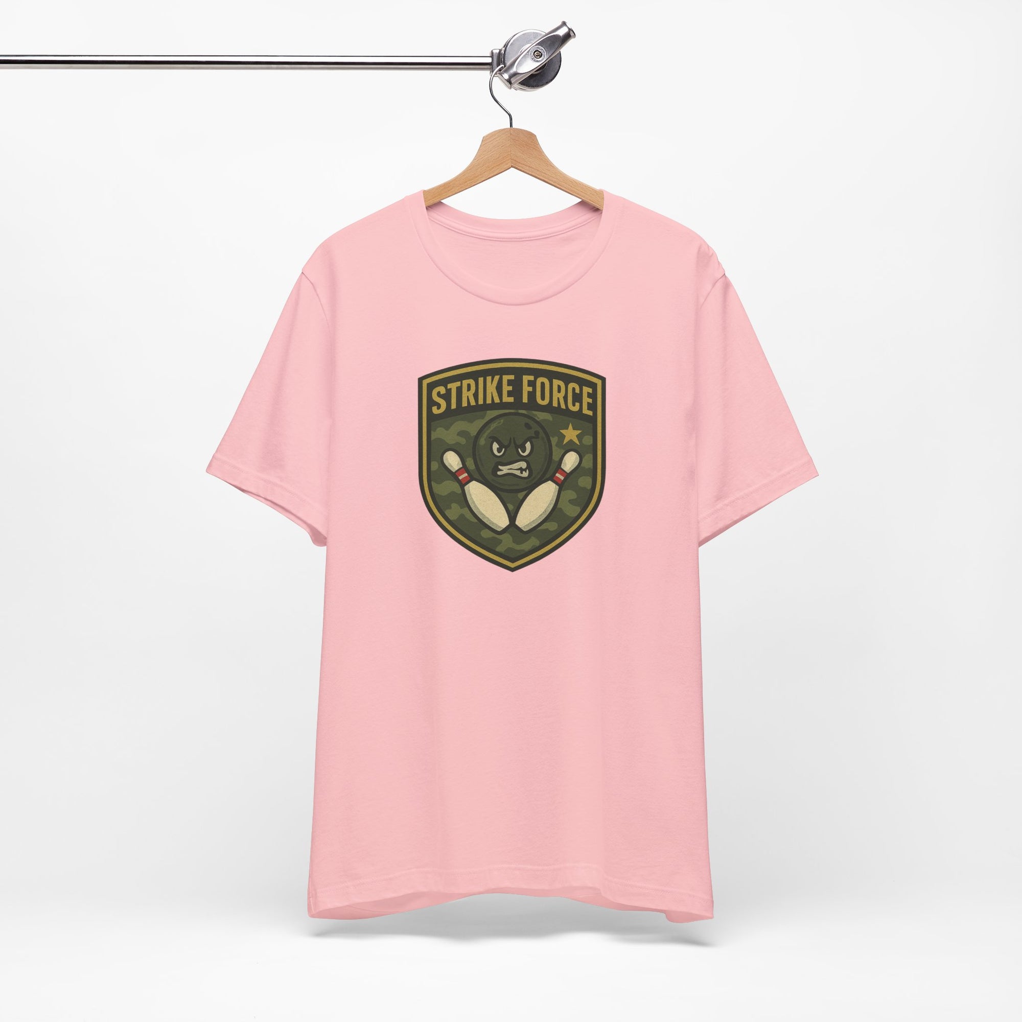 Pink t-shirt with bowling 'Strike Force' military-style patch on a hanger against a white background