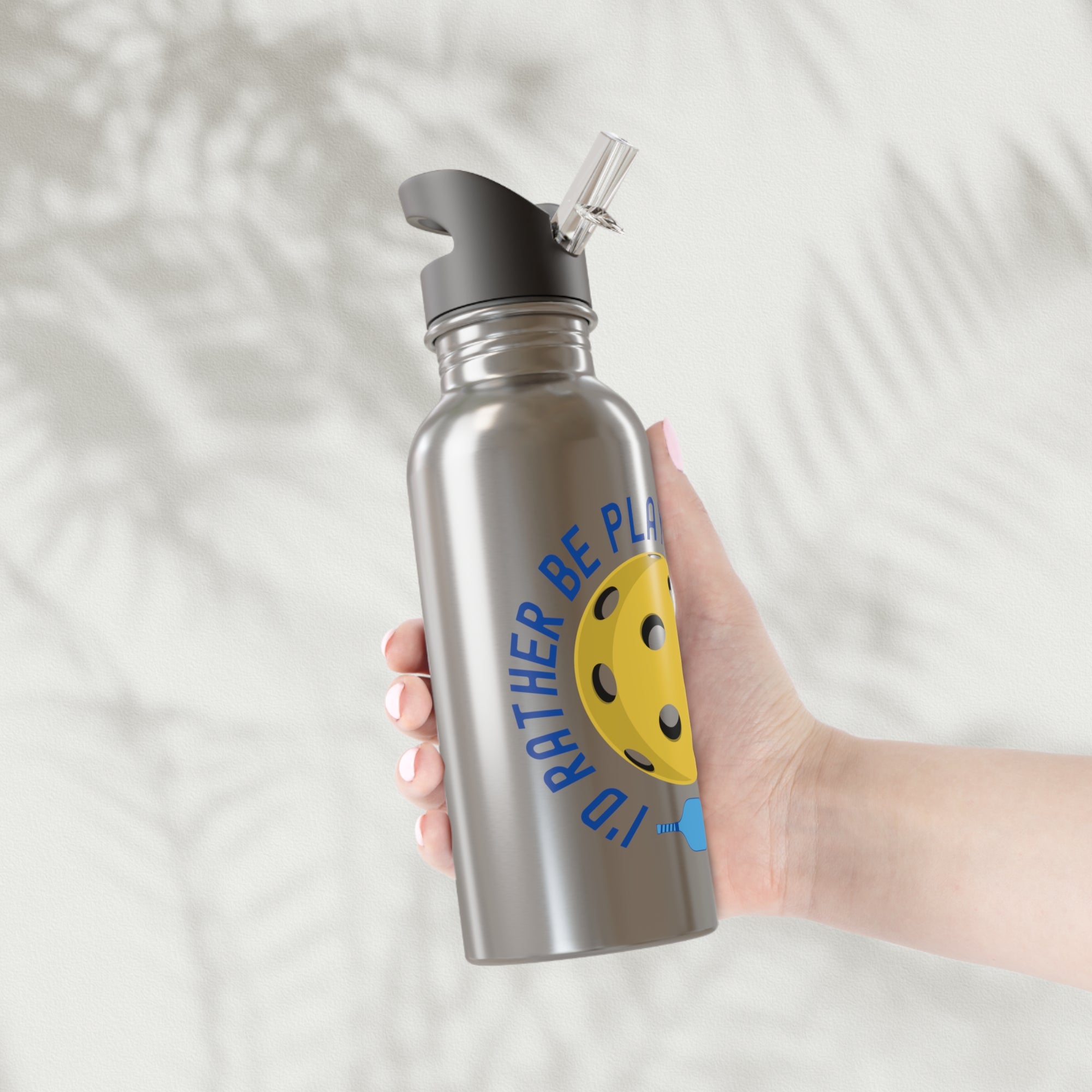 Person holding a stainless steel water bottle with a yellow pickleball and paddle and the text "I'd Rather Be Playing Pickleball" on a white background
